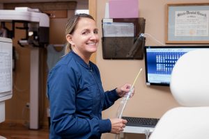 Dental hygienist preparing tools for a professional teeth cleaning.