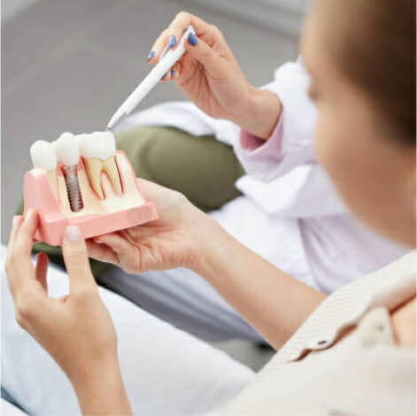 A dental demonstration featuring a demo tooth with a dental restoration