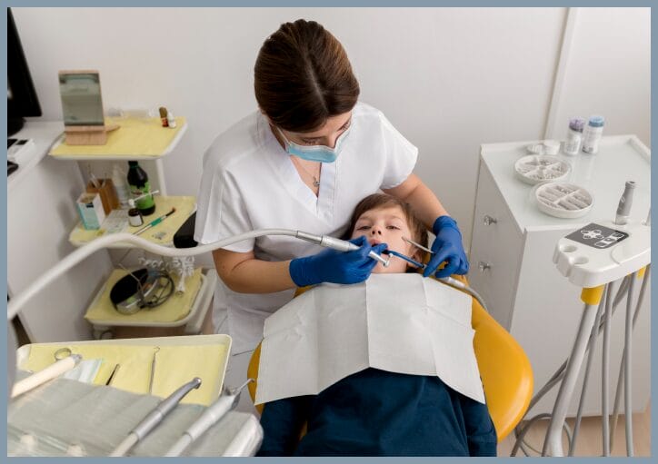 Dentist applying dental sealants to a child’s teeth during a preventive care visit.